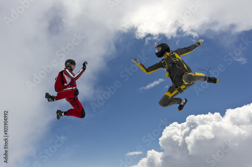 Two parachutists girls in free fall.