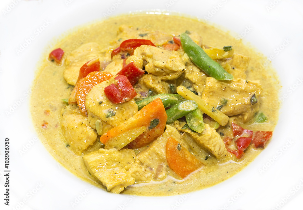 chicken curry with vegetables on a white plate in a restaurant chicken curry with vegetables on a white plate in a restaurant