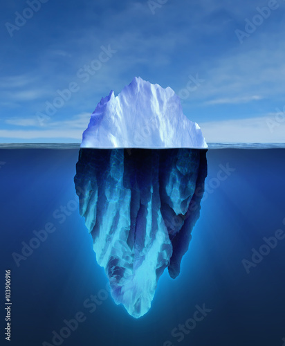Big iceberg floating on blue ocean.