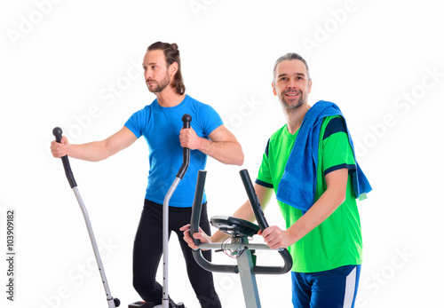 two young man train with fitness machine
