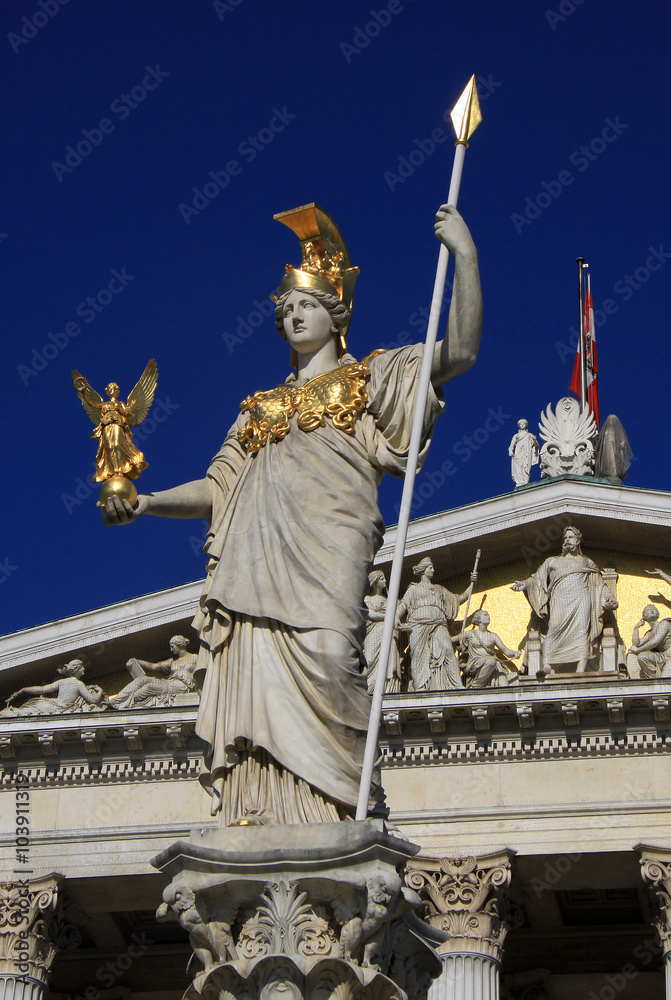 Fototapeta premium VIENNA, AUSTRIA - APRIL 26, 2013: Statue of Pallas Athena, Goddess of Wisdom, standing in front of the Austrian Parliament building in Vienna
