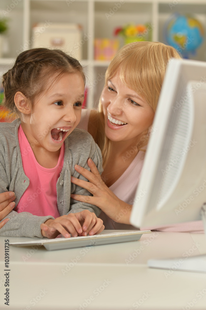 girl playing with mother on computer girl playing with mother on computer