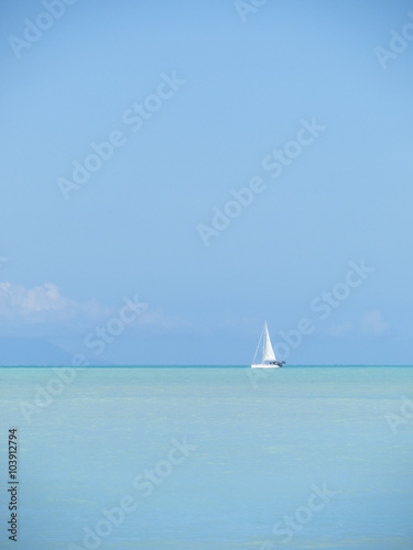 Sailboat cruising beautiful turquoise waters of the Caribbean