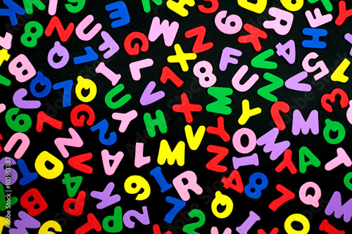 Colorful letters and numbers on black background.
