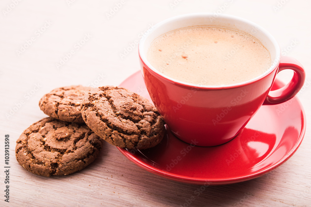 Coffee cup with chocolate cookies on kitchen table Coffee cup with chocolate cookies on kitchen table