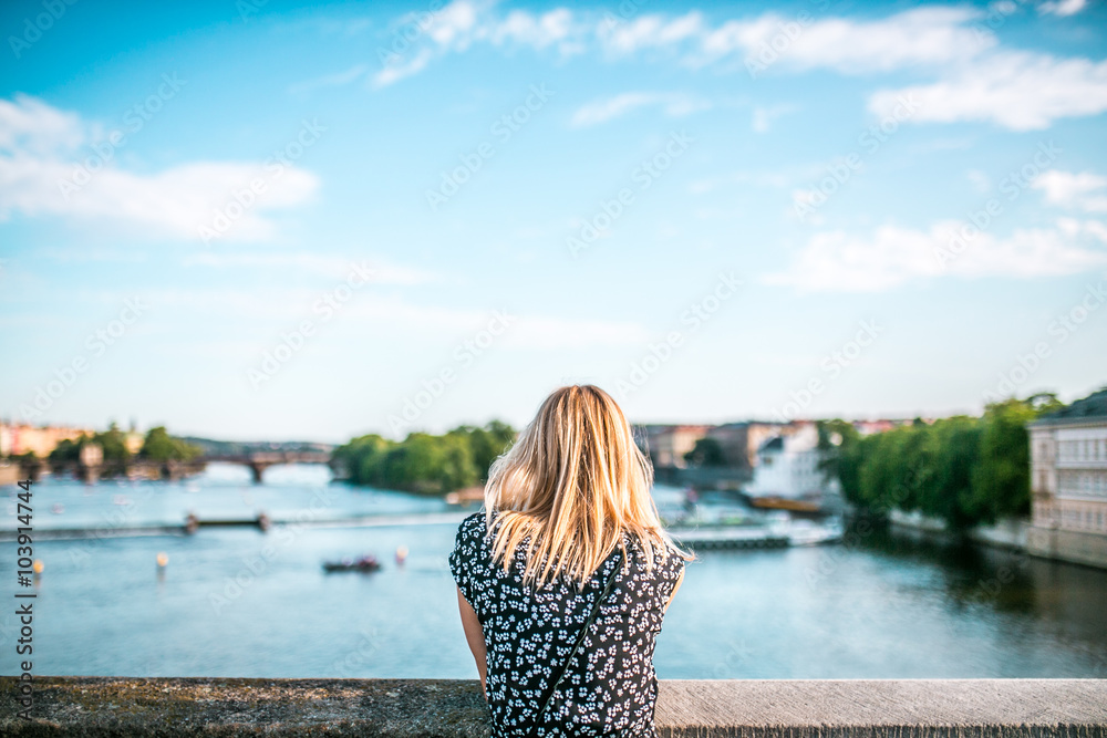 People on the bridge in Prague looking at the landscape