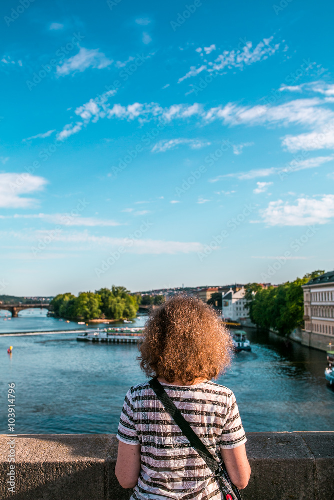 People on the bridge in Prague looking at the landscape
