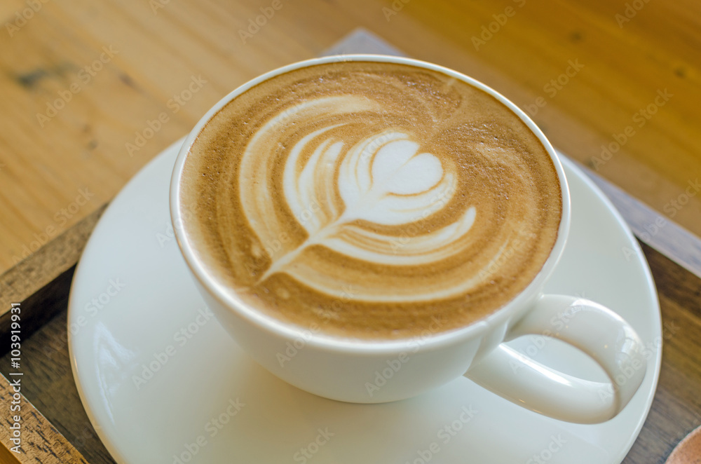 white cup of coffee on wood table white cup of coffee on wood table