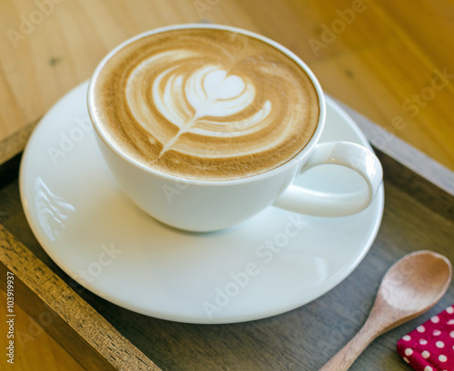 white cup of coffee on wood table