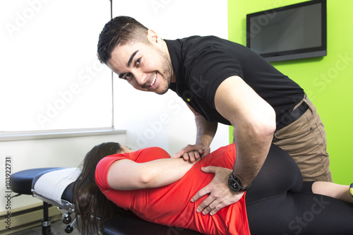 Physical therapist doing mobilisation of the spine photo