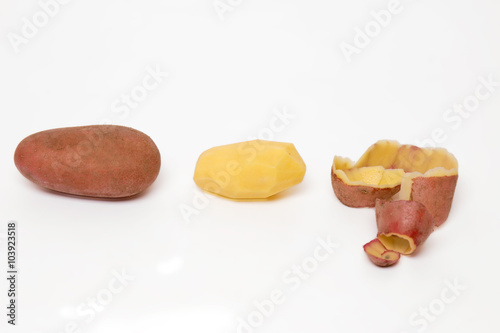 potato pealing process on a white background. photo