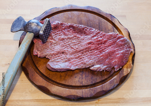 meat tenderizer and beaten slice of veal photo