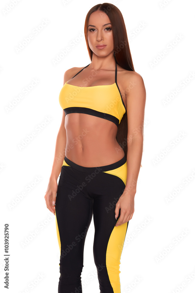 Fototapeta premium Fitness woman in sport style standing against isolated white background