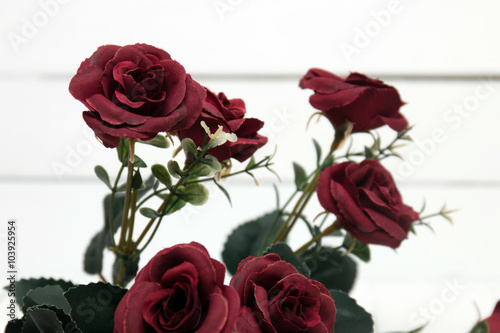 Fake bouquet of red roses isolated on a white background.