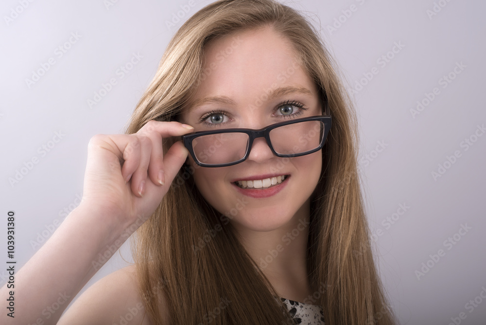 Attractive teenage girl wearing spectacles with a black frame
