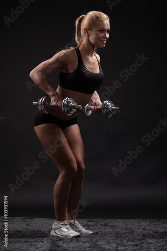 fitness woman in doing exercises with dumbells.