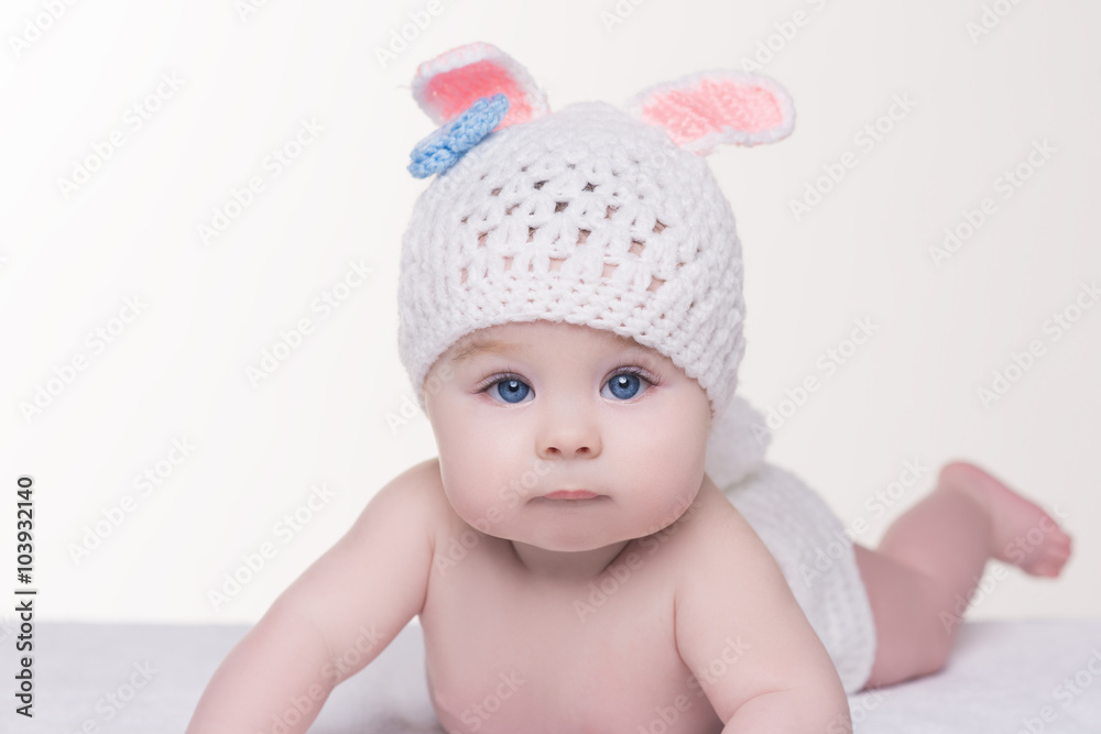 portrait of baby in white knitted hat with ears bunny portrait of baby in white knitted hat with ears bunny