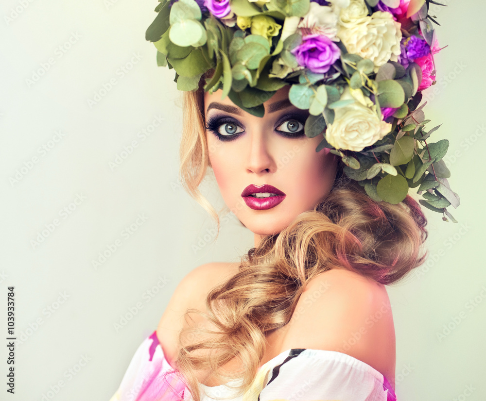 Girl spring . Beautiful model with flower wreath on his head . Makeup smoky eyes . Summer girl with trendy makeup .