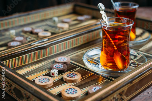 Turkish sweets and tea on the backgammon Board photo