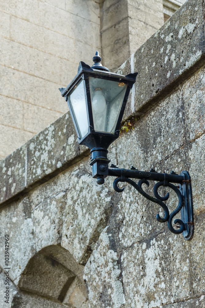 Old-fashioned street lamp against the building. Powerscourt. Ireland. Old-fashioned street lamp against the building. Powerscourt. Ireland.