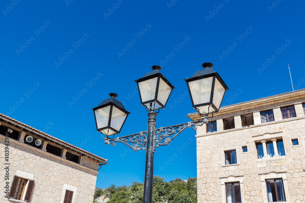 Old-fashioned street lamp against the building. Lluc Monastery. Majorca. Spain.