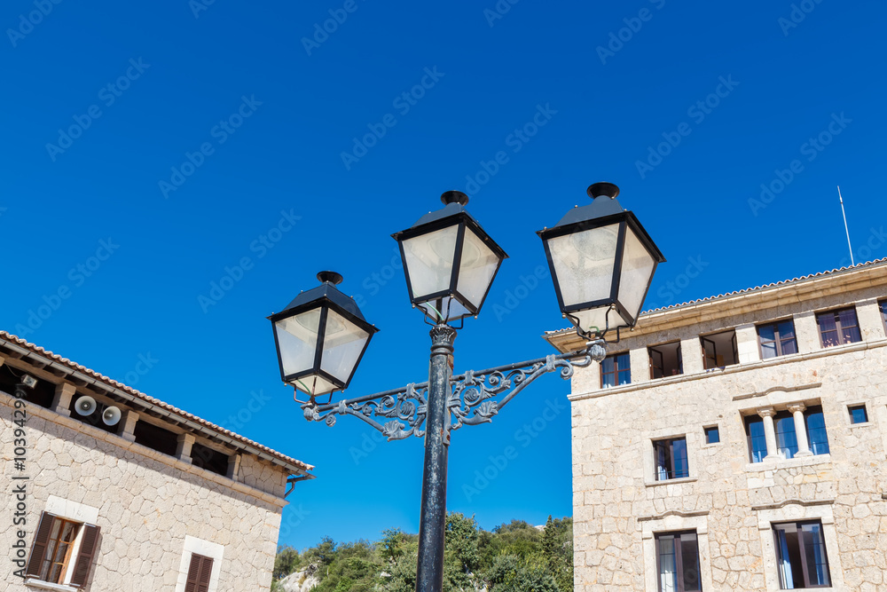 Old-fashioned street lamp against the building. Lluc Monastery. Majorca. Spain. Old-fashioned street lamp against the building. Lluc Monastery. Majorca. Spain.