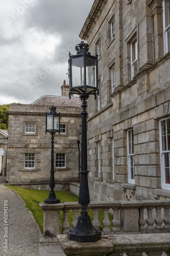 Old-fashioned street lamp against the building. Powerscourt. Ireland. 