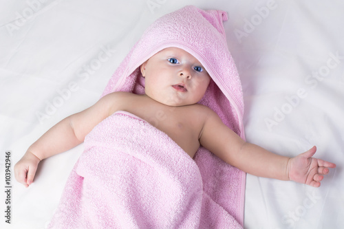 Sweet small baby covered with a towel