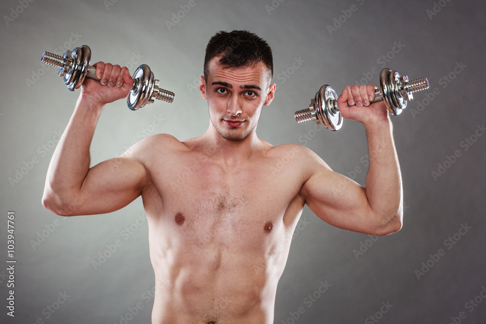 athletic man working with heavy dumbbells athletic man working with heavy dumbbells