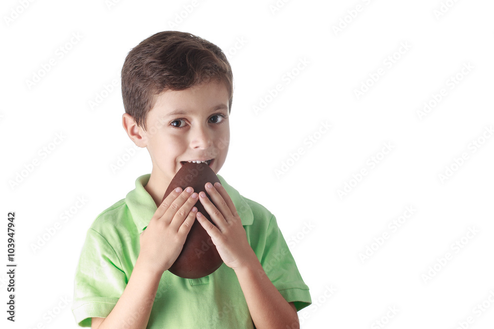 Little boy eating chocolate easter egg on white background Little boy eating chocolate easter egg on white background