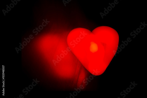 Light shine love heart over black. photo