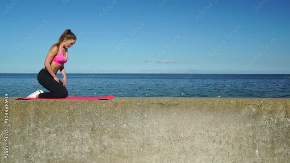 Woman doing sports exercises outdoors by seaside 4K Woman doing sports exercises outdoors by seaside 4K