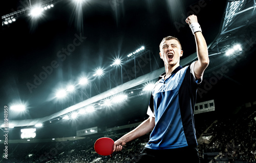 Bild auf Leinwand Young handsome sportsman celebrating flawless victory in table tennis