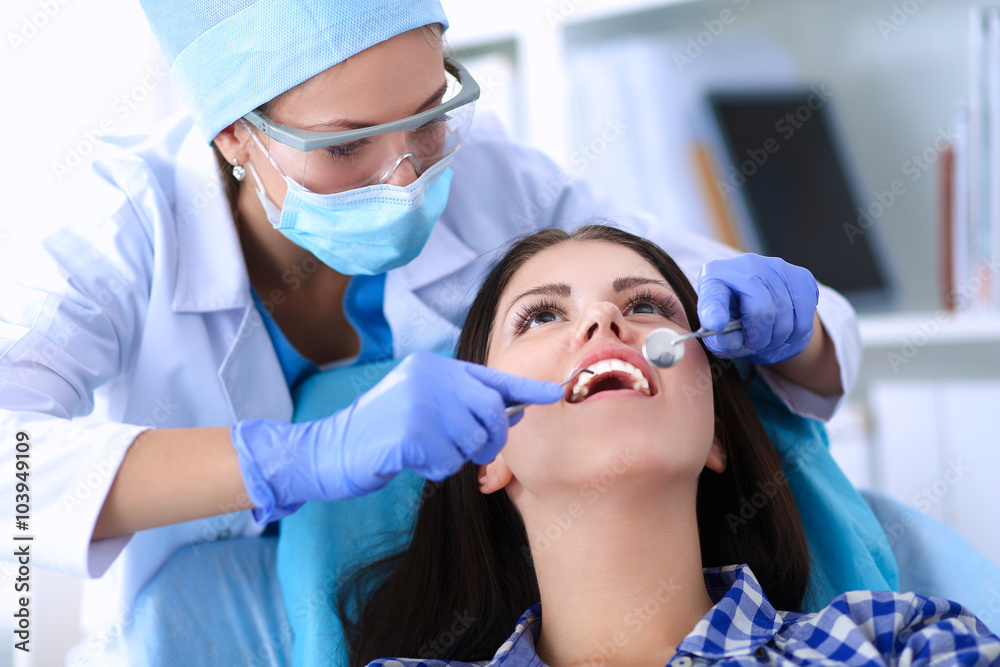 Woman dentist working at her patients teeth Woman dentist working at her patients teeth