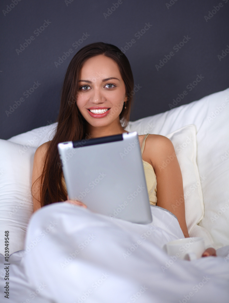 Women use a tablet pc on the bed Women use a tablet pc on the bed