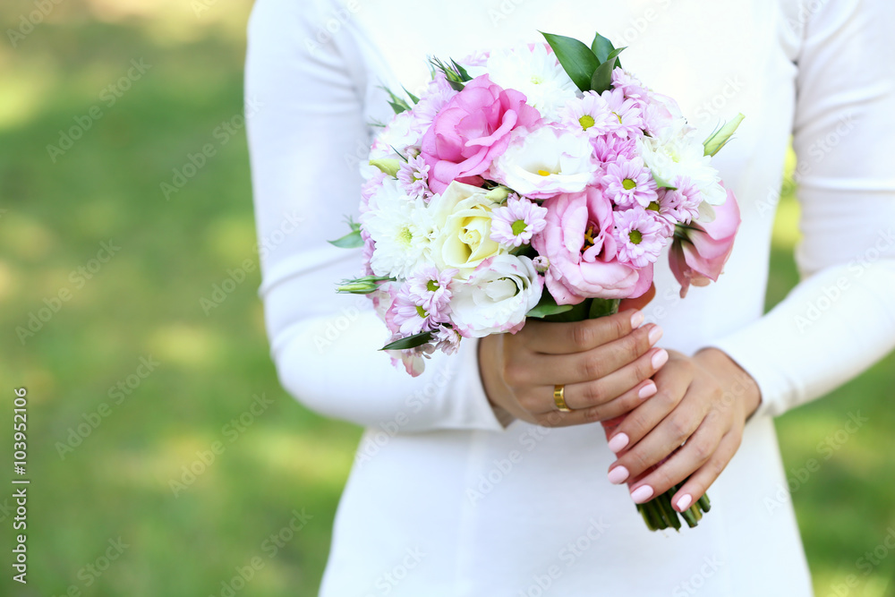 Beautiful wedding bouquet in hands of bride Beautiful wedding bouquet in hands of bride