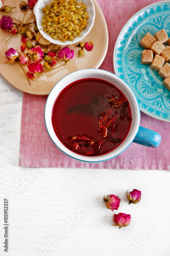 Cup of tea with aromatic dry tea on wooden background