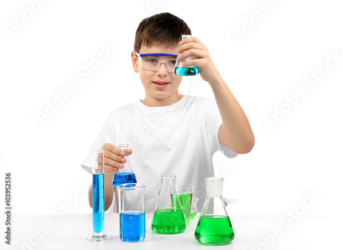Clever little boy doing a chemical experiments, isolated on white