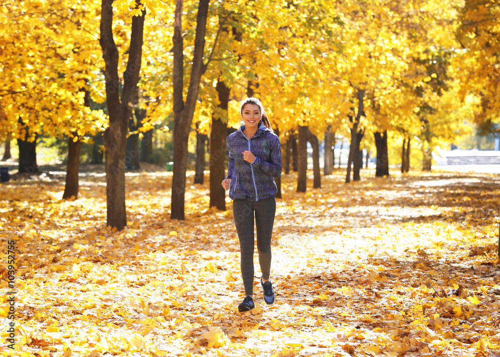 Young beautiful woman jogging in autumn park Young beautiful woman jogging in autumn park