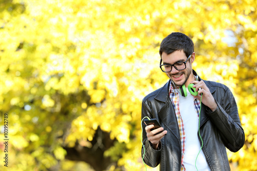 Young man in a park listening to music