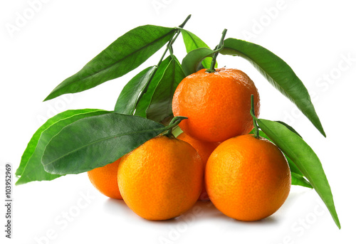 Ripe tangerines with green leaves isolated on white