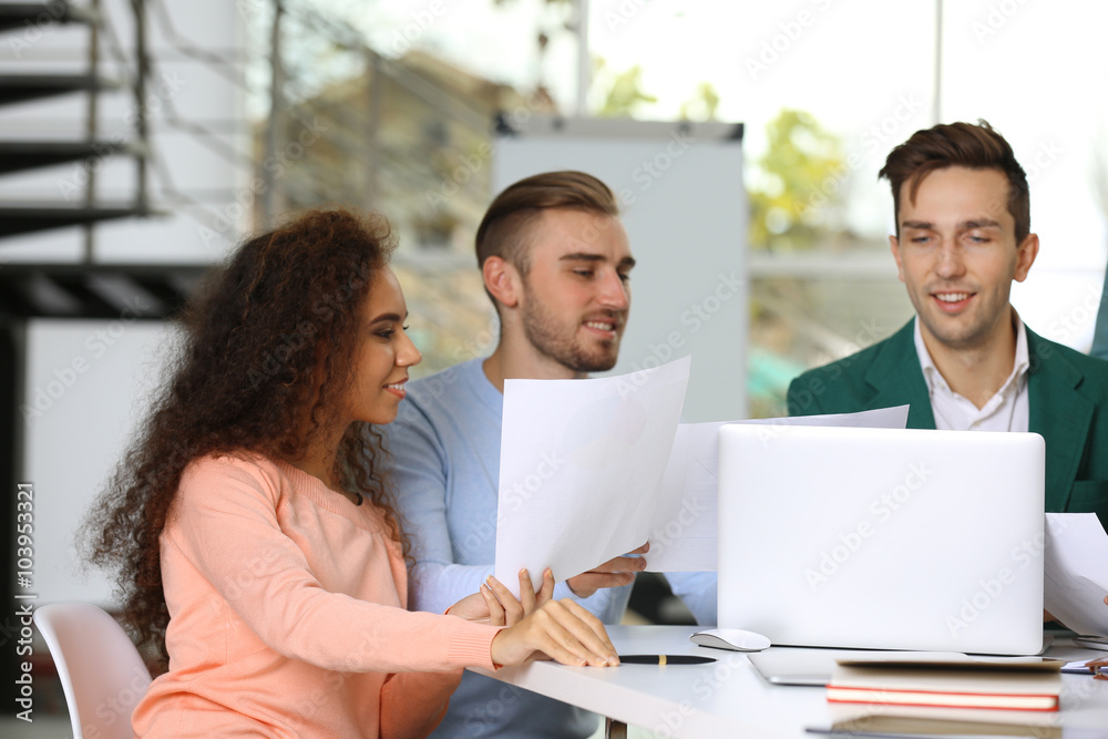 Young business people discussing a new project at the meeting in a conference room Young business people discussing a new project at the meeting in a conference room