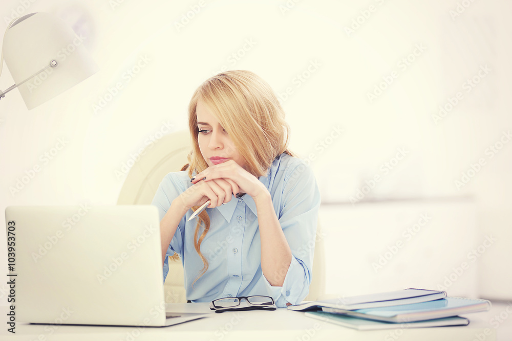 Tired woman at the laptop in office