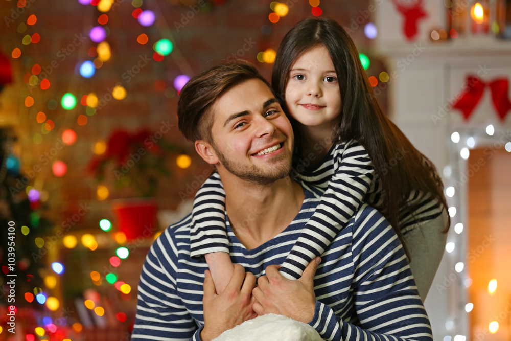 Older brother with little sister embracing in Christmas living room Older brother with little sister embracing in Christmas living room