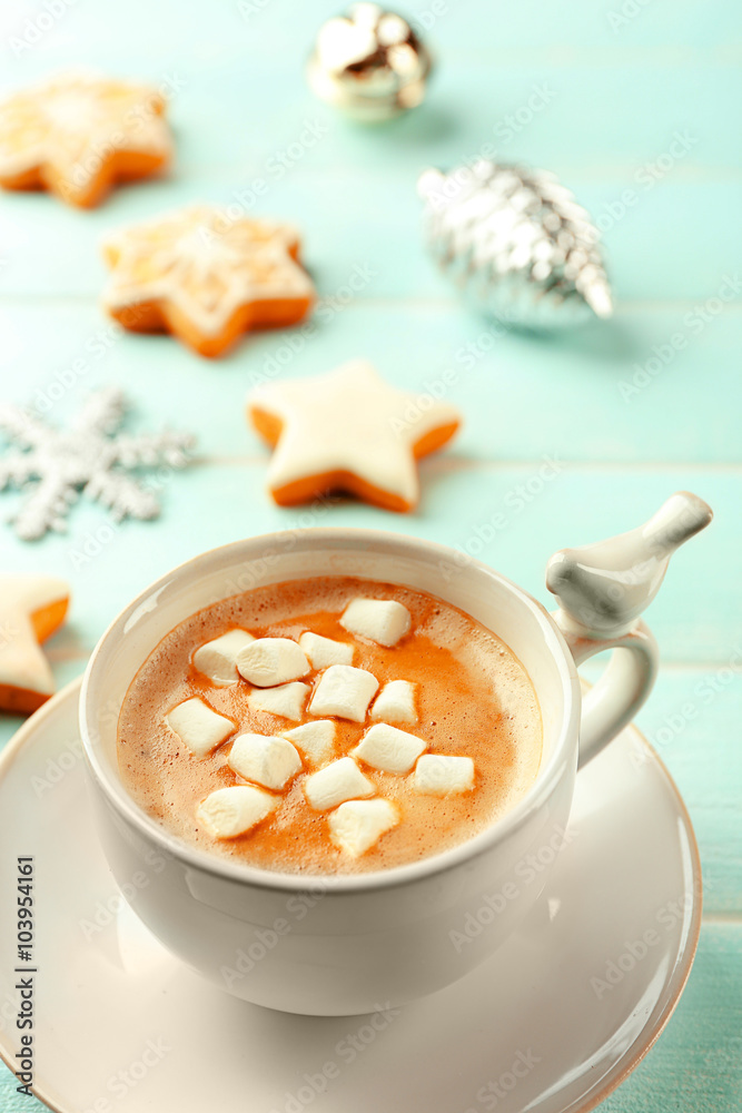 Cup of hot cacao with marshmallow and cookies on blue table Cup of hot cacao with marshmallow and cookies on blue table