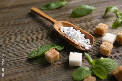 Sugar cubes and stevia  on wooden background photo