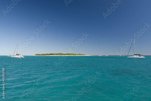 Idyllic island and two boats photo