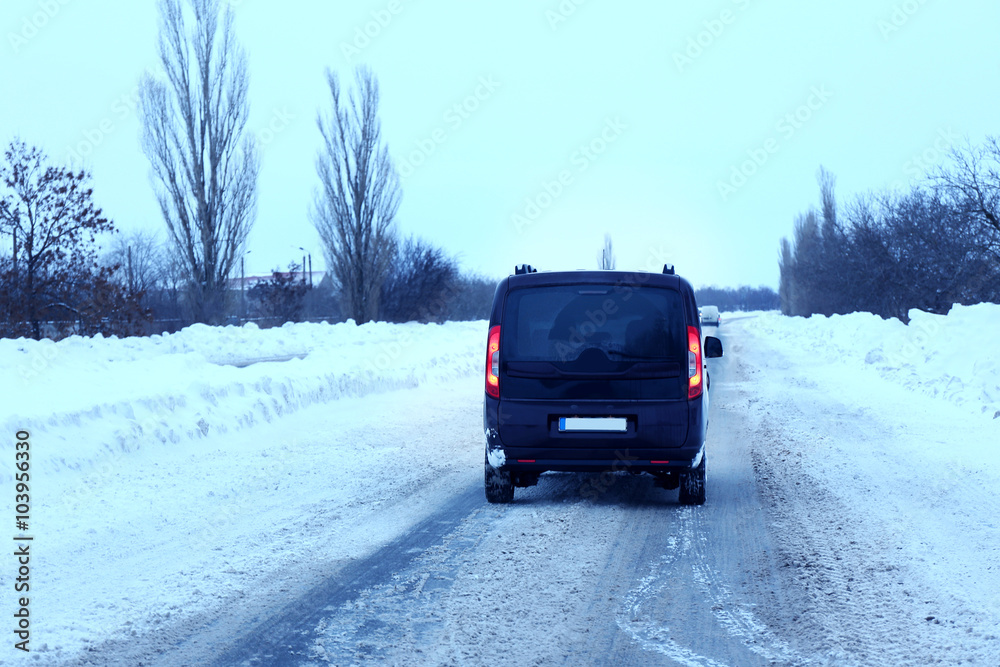 Car driving on snowy winter road, outdoor