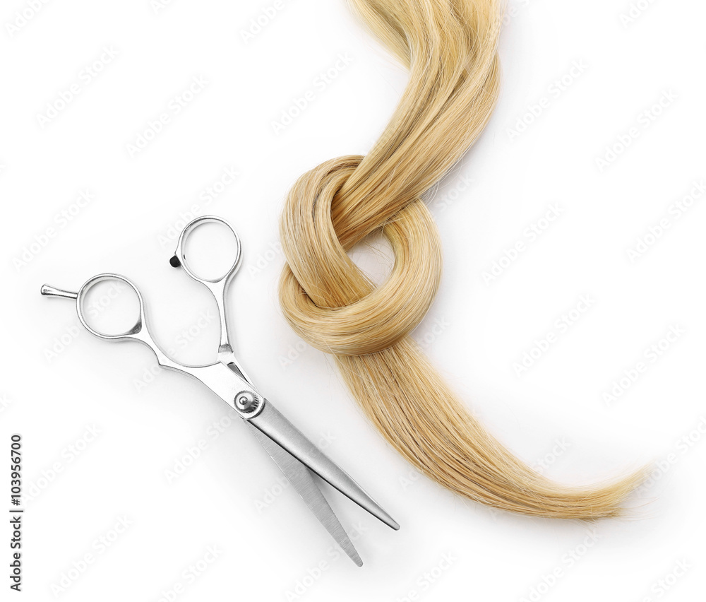 Hairdresser's scissors with strand of blonde hair, isolated on white Hairdresser's scissors with strand of blonde hair, isolated on white