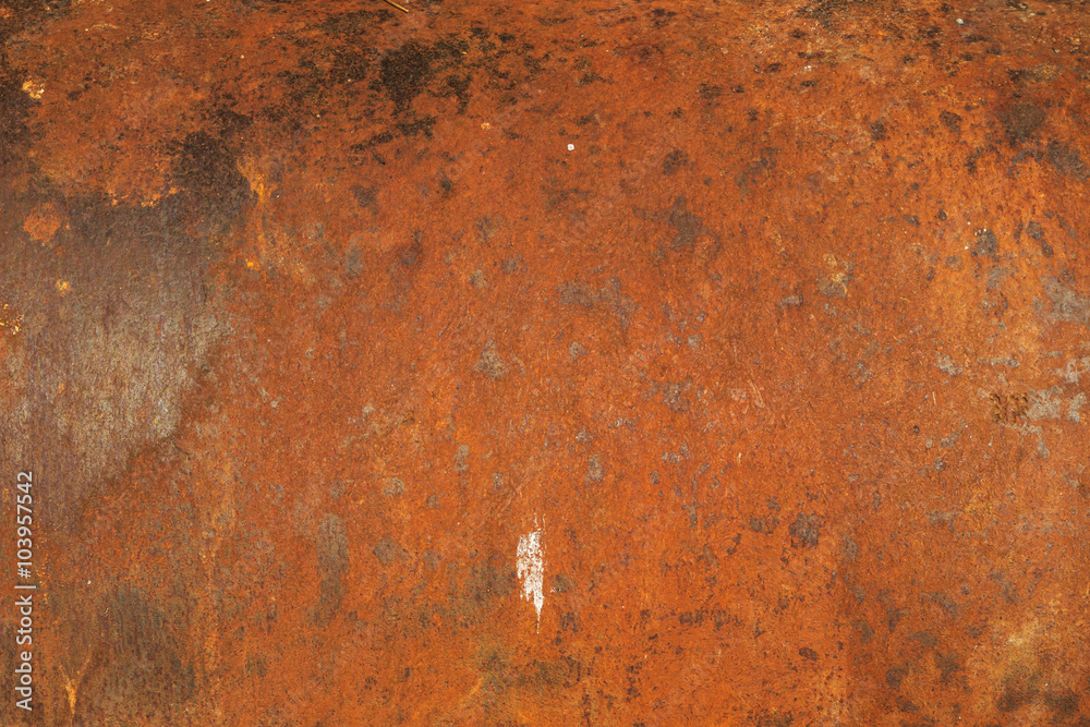 Red rust on the old and weathered metal door